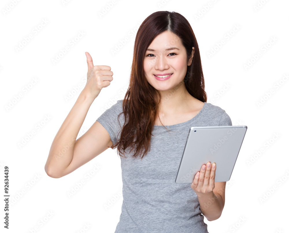 Asian woman use of the tablet pc and thumb up gesture Asian woman use of the tablet pc and thumb up gesture