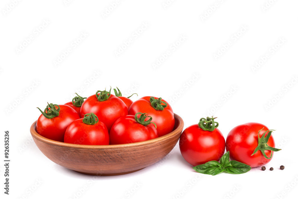 Fresh tomatoes in a bowl with basil isolated Fresh tomatoes in a bowl with basil isolated