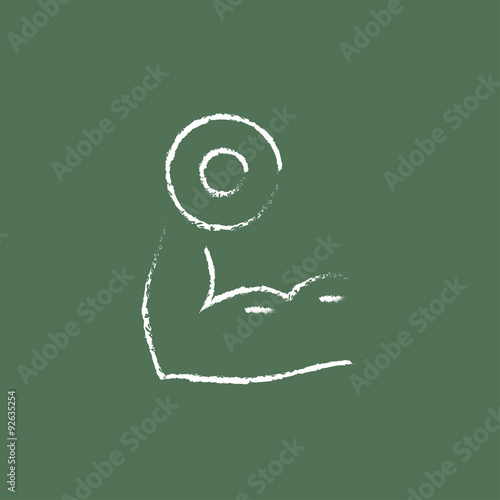 Arm with dumbbell icon drawn in chalk.