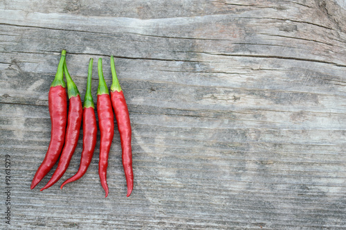 Hot peppers on the old gray wooden board