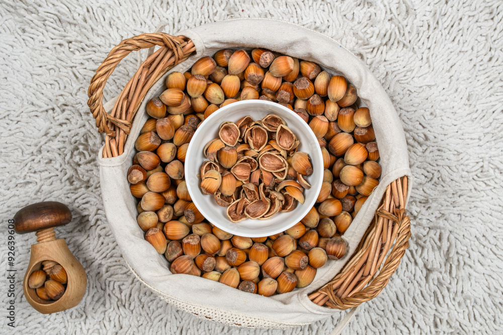 Many hazel nuts in wicker basket