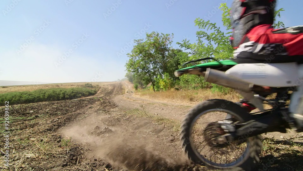 Motocross racer starting engine of his dirt bike riding away kicking up dust Stock Video Adobe