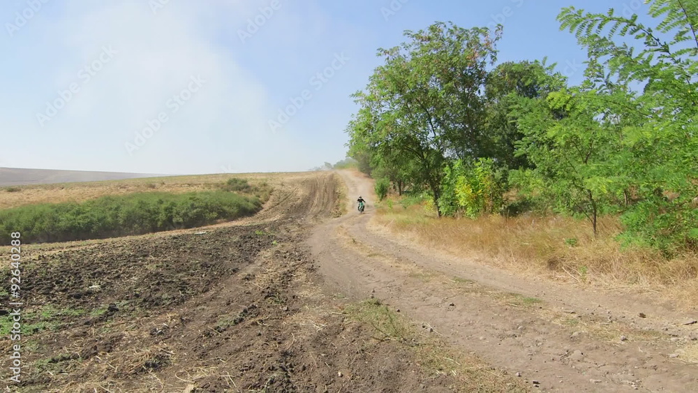 Enduro racer riding offroad bike on dirt track jib crane shot Enduro racer riding offroad bike on dirt track jib crane shot