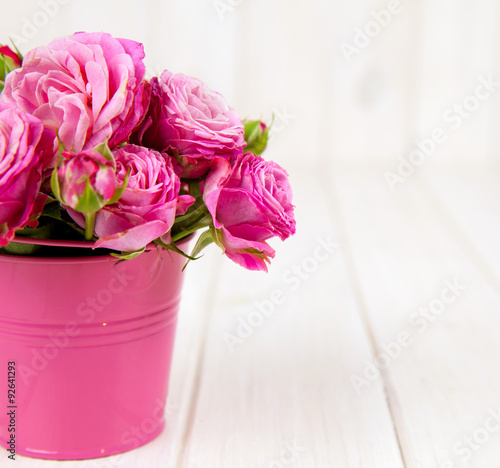Fototapeta Naklejka Na Ścianę i Meble -  Pink roses(peony) in vase on white wooden background. flowers