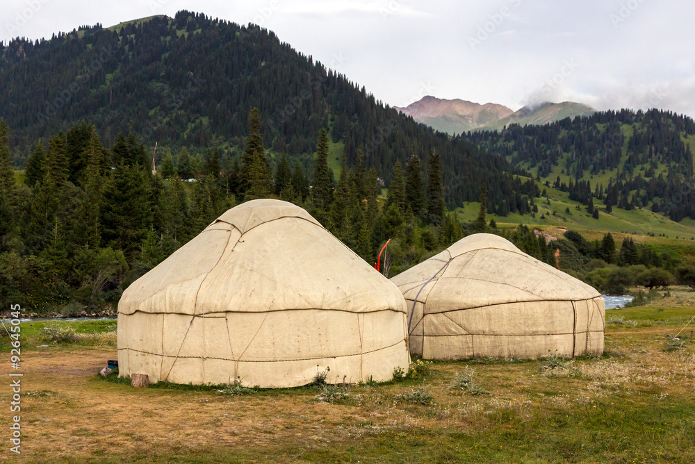 Yurts in Central Asian Veld
Two Traditional Mongol Nomad Housings assembled on Green Meadow among High Mountain Hills in Kyrgyzstan Yurts in Central Asian Veld
Two Traditional Mongol Nomad Housings assembled on Green Meadow among High Mountain Hills in Kyrgyzstan