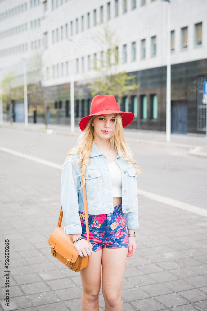 Knee figure of young beautiful blonde caucasian girl posing in t