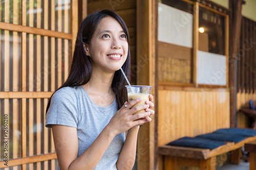 Woman drinking of coffee in cafe © leungchopan