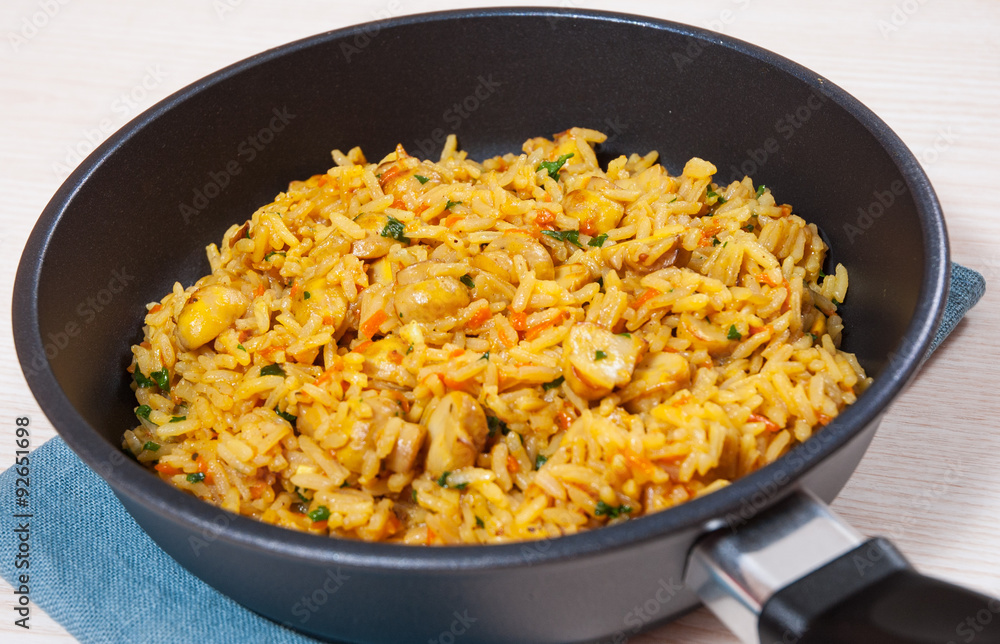 rice with mushrooms in a frying pan rice with mushrooms in a frying pan