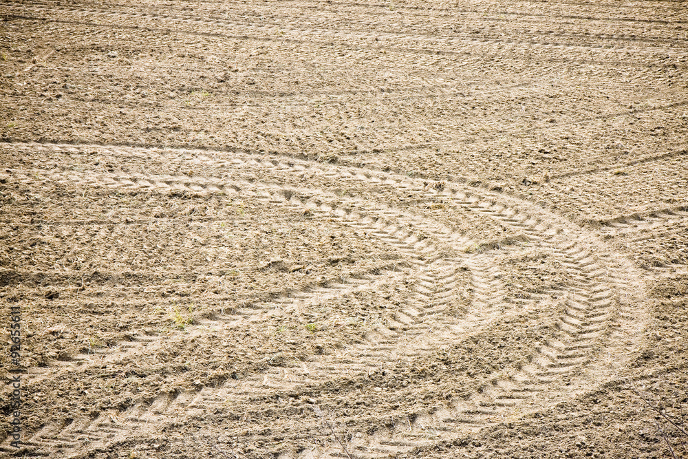 Tractor footprints on plowed field - full frame image Tractor footprints on plowed field - full frame image