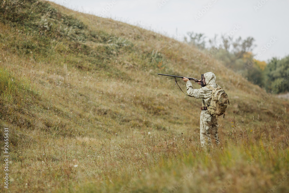 hunter in camouflage clothes ready to hunt with hunting rifle hunter in camouflage clothes ready to hunt with hunting rifle