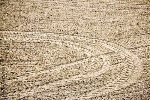 Tractor footprints on plowed field - full frame image
