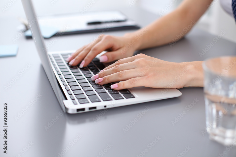 Close up of business woman hands typing on laptop computer Close up of business woman hands typing on laptop computer