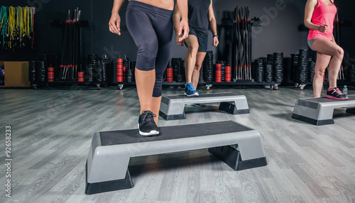 Photos People legs over steppers training in aerobic class