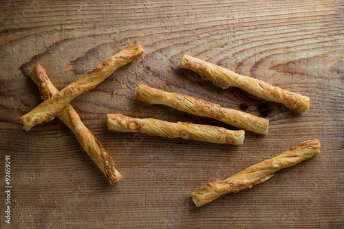 pastry sticks with cheese on wooden table