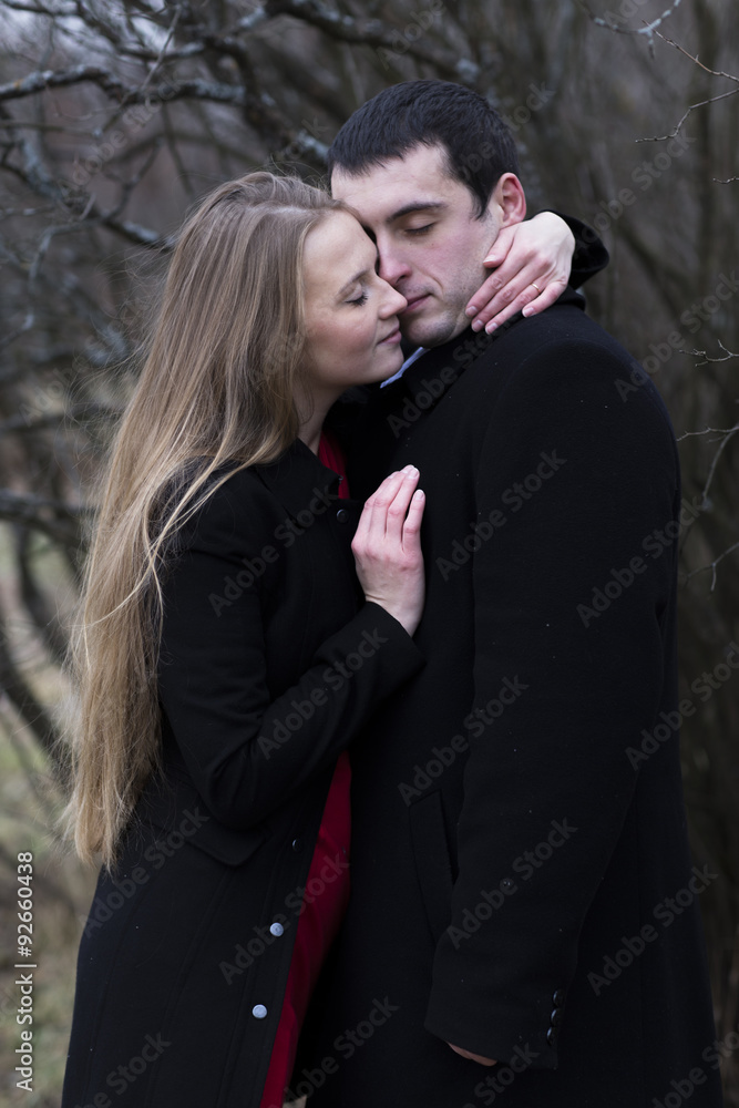 young couple hugging in falls park young couple hugging in falls park