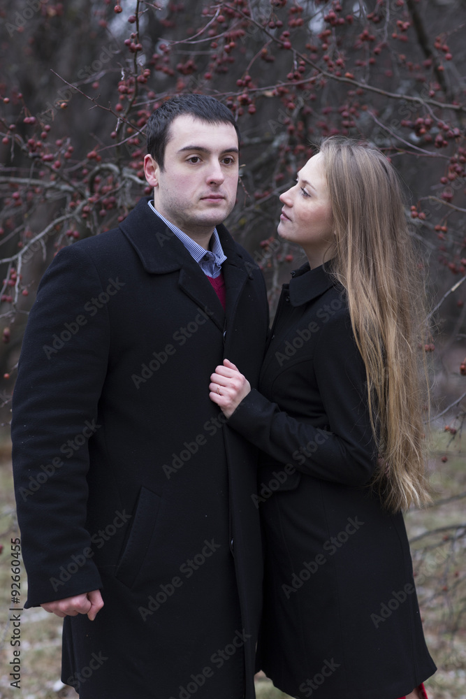young attractive woman looking to man in park young attractive woman looking to man in park