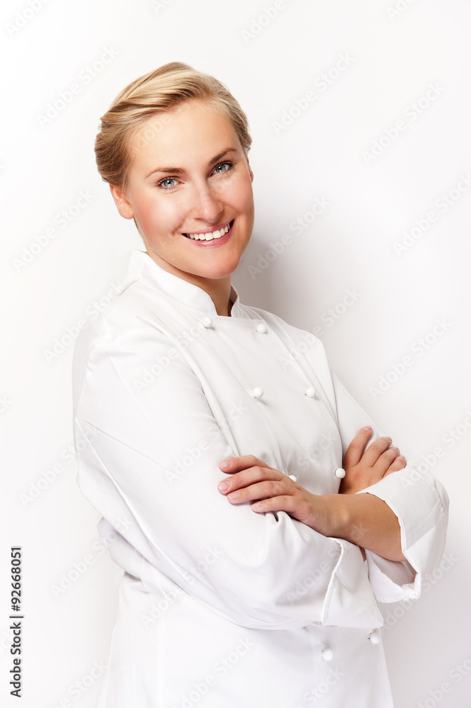 Young woman chef smiling over white background in chef's outfit. Young woman chef smiling over white background in chef's outfit.