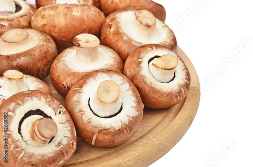 Champignon (True mushroom) on wooden board, isolated on white background