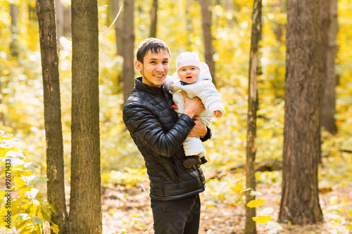 happy young father with his daughter spending time outdoor in