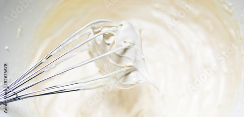 Whipping cream with a whisk close up
