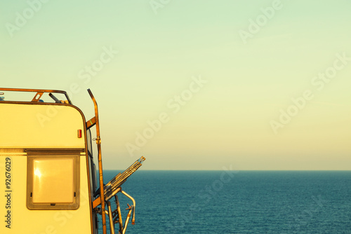 Part of camper on the seashore at sunset photo