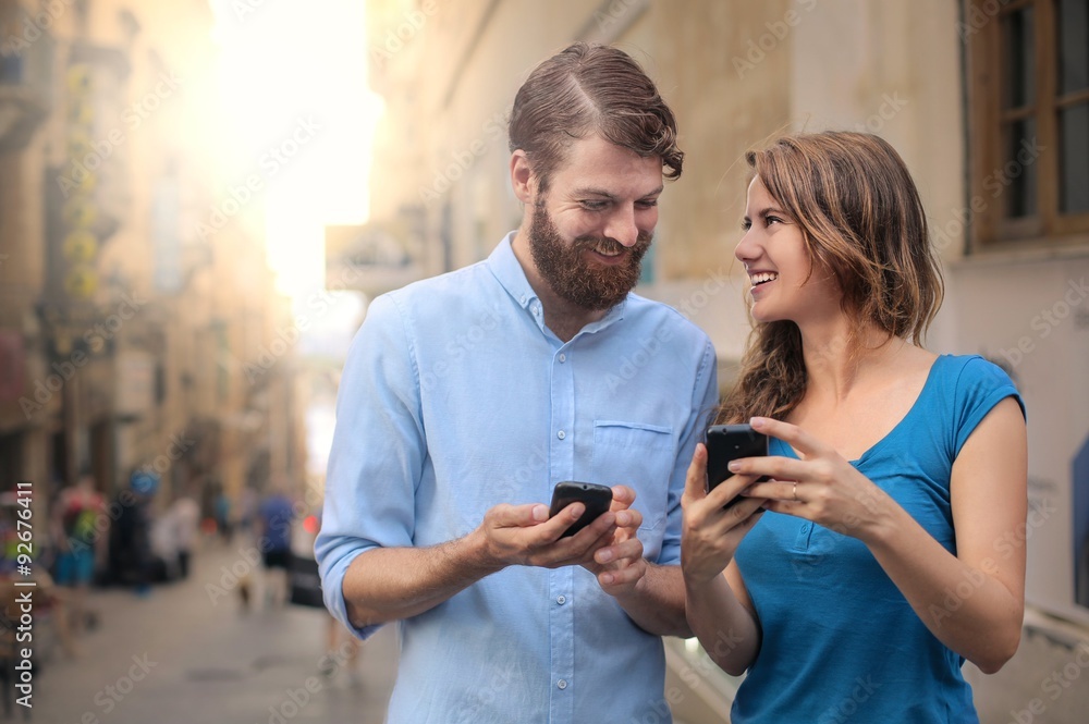 Man and woman using smartphones Man and woman using smartphones