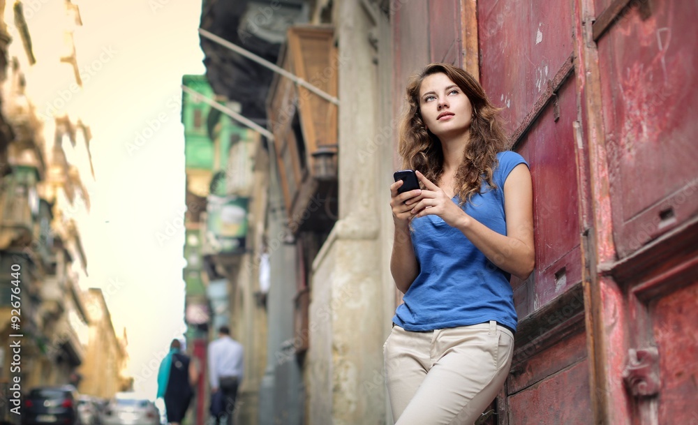 Young woman holding a smartphone in her hands Young woman holding a smartphone in her hands