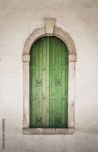 Ancient stone window with wooden balcony