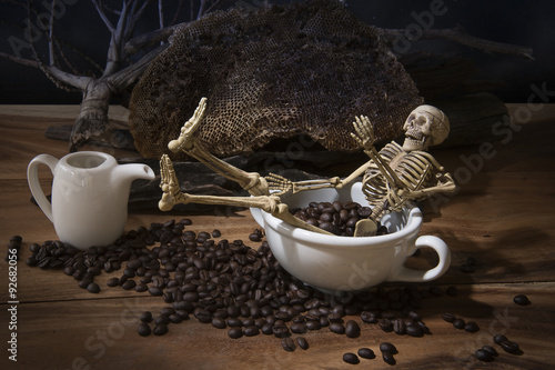 Still life with skull and death. Skeleton with coffee beans