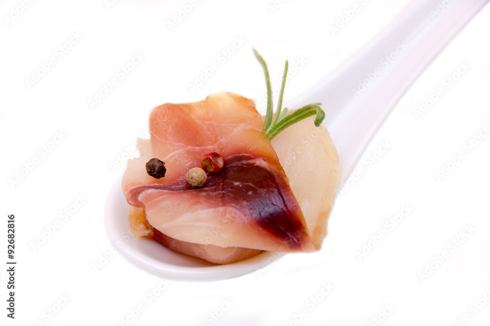 Smoked swordfish on teaspoon on white background seen close Smoked swordfish on teaspoon on white background seen close