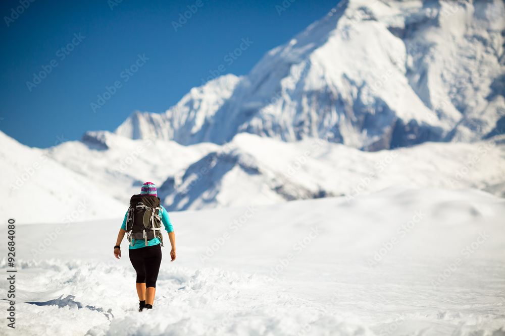 Woman walking in winter mountains