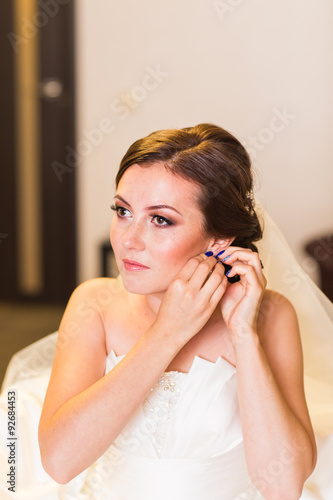 Beautiful young bride with wedding makeup and hairstyle