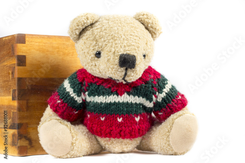 Teddy bear with red wool coat, on white