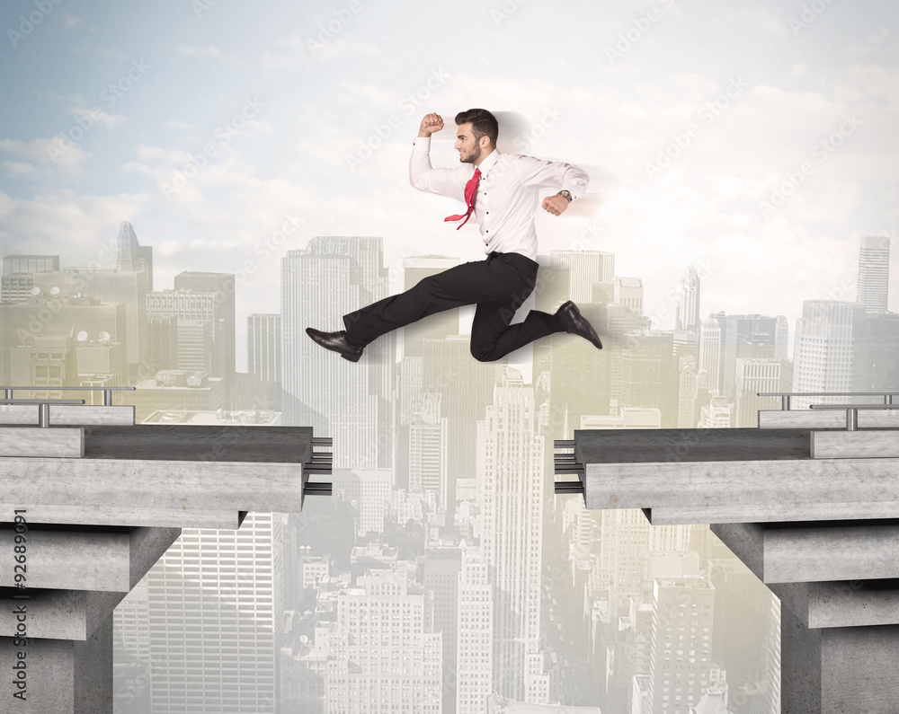 Energetic business man jumping over a bridge with gap Energetic business man jumping over a bridge with gap
