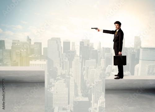 Businessman standing on the edge of rooftop