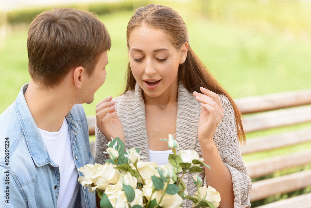 Boy presenting flowers to girl 