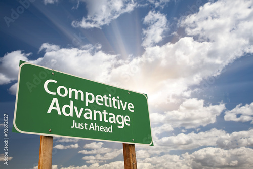 Competitive Advantage Green Road Sign Over Clouds photo