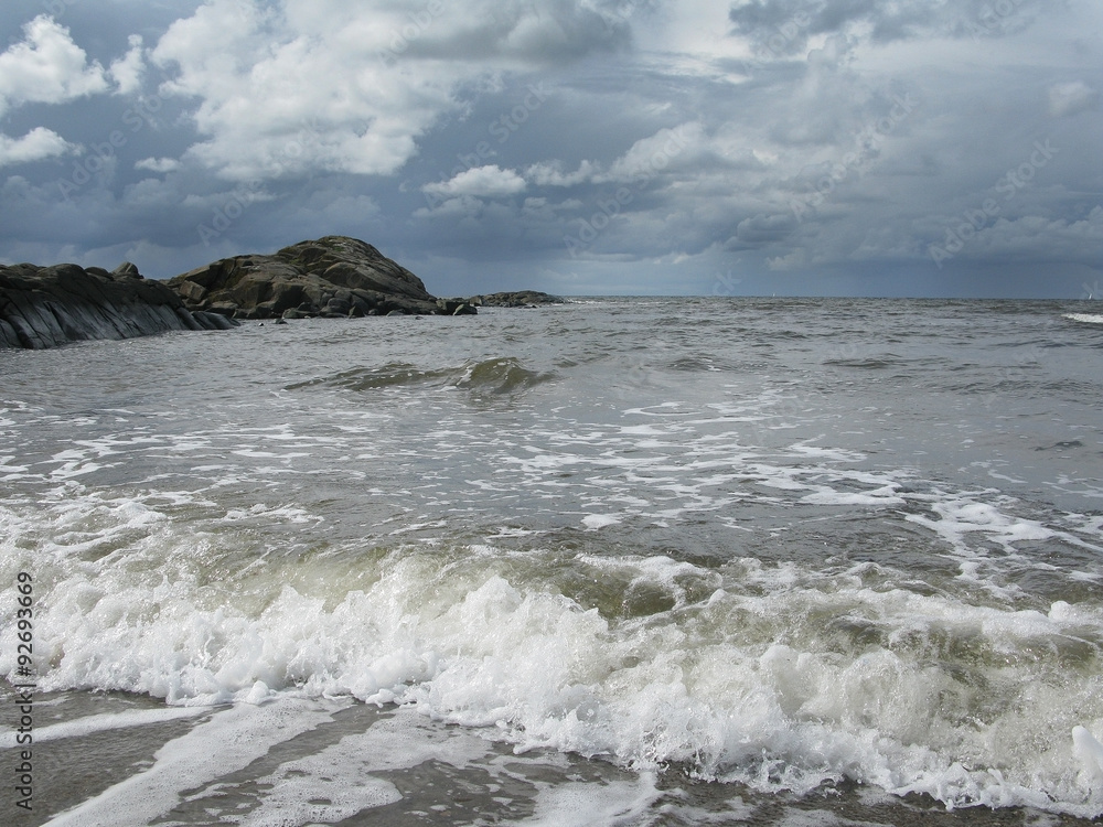 Natural landscape at Skrea Strand on a sunny day with dark clouds in Falkenberg, Sweden.