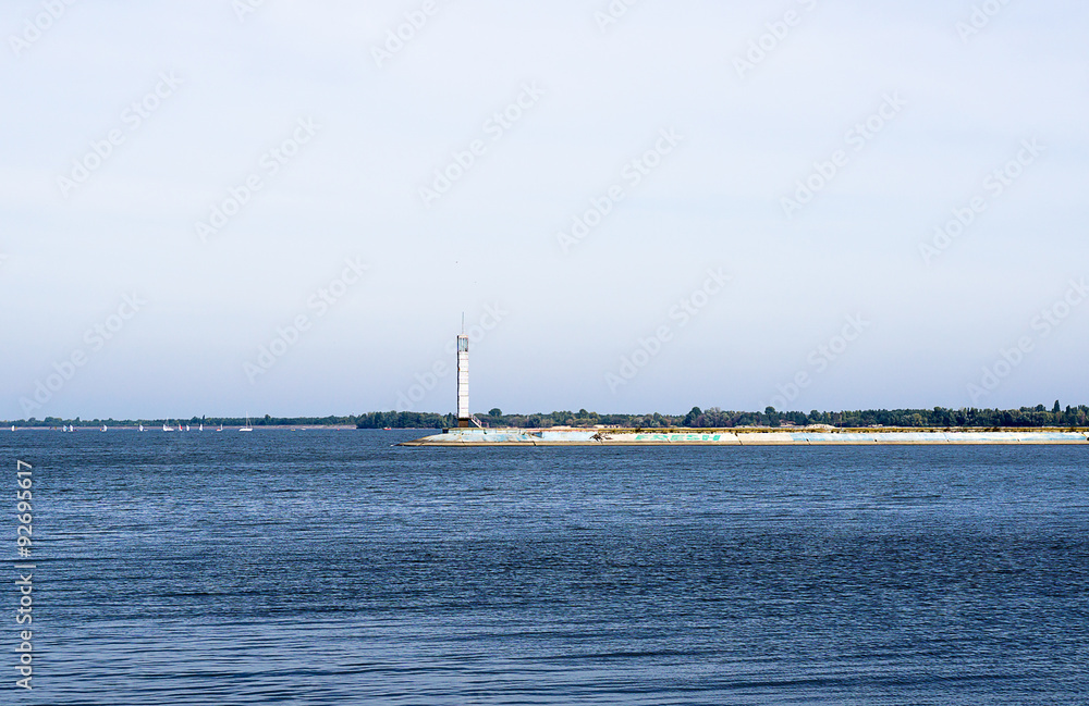 Contrast sea panorama with lighthouse on the pier