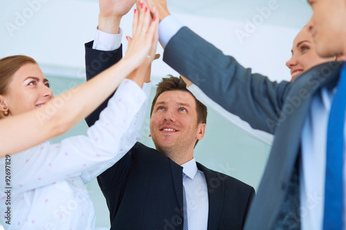 Business people with their hands together in a circle