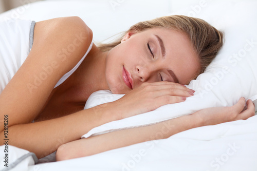 Beautiful girl sleeps in the bedroom