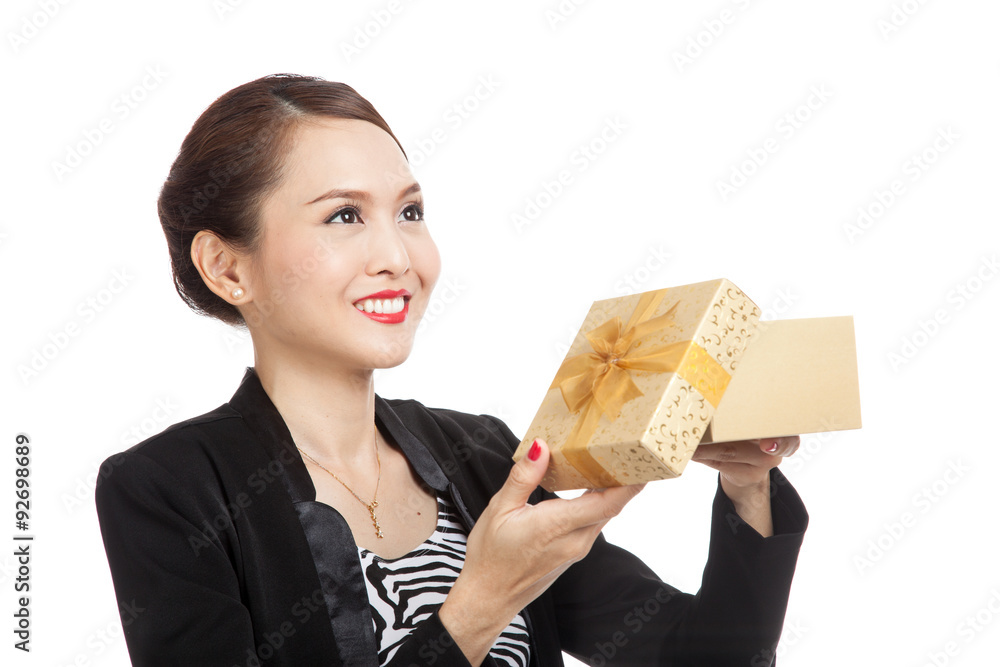 Young Asian business woman open a golden gift box Young Asian business woman open a golden gift box