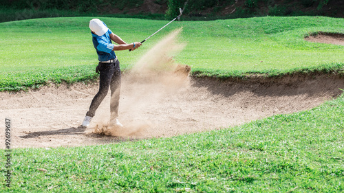 Yong asian golfer explosion sand.