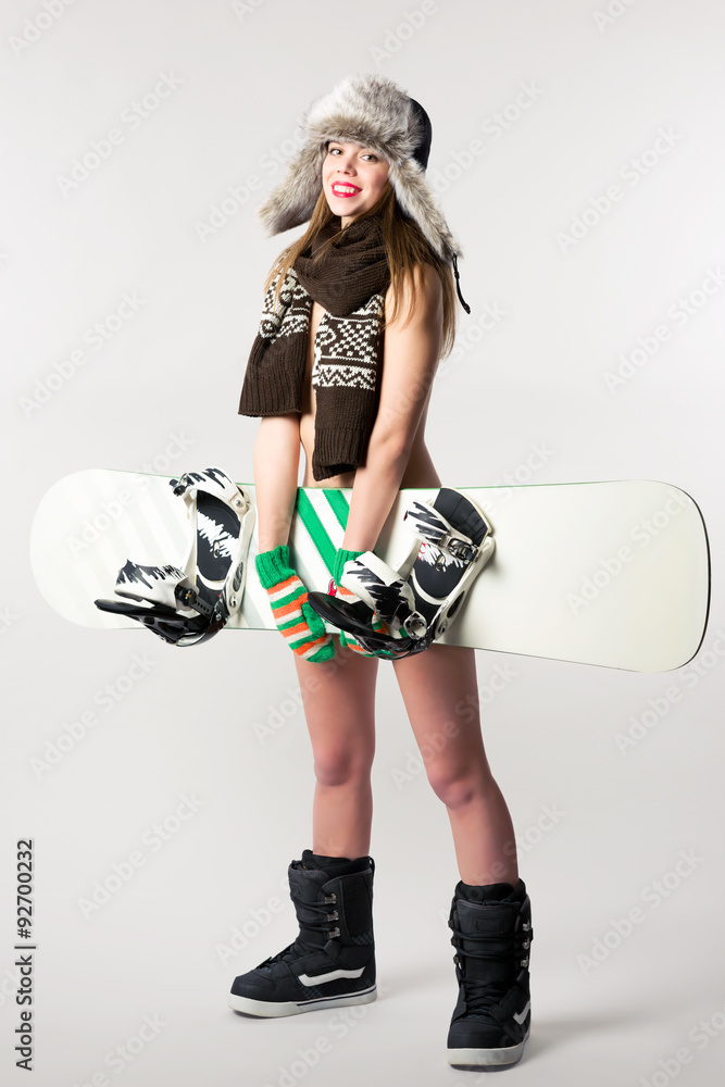 Half naked girl in a hat with earflaps with snowboard Stock Photo | Adobe  Stock