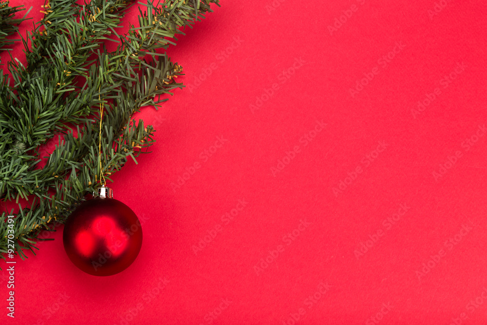 Simple red Christmas background with fir tree and ornaments.