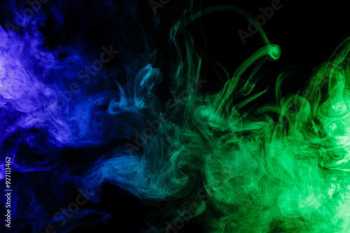 Fototapeta Naklejka Na Ścianę i Meble -  Abstract blue and green smoke hookah on a black background.
