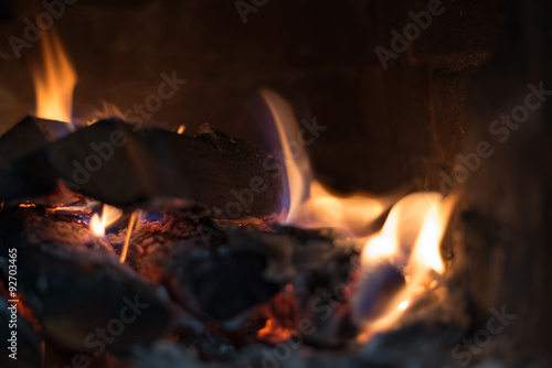 Wooden logs in stove with flame