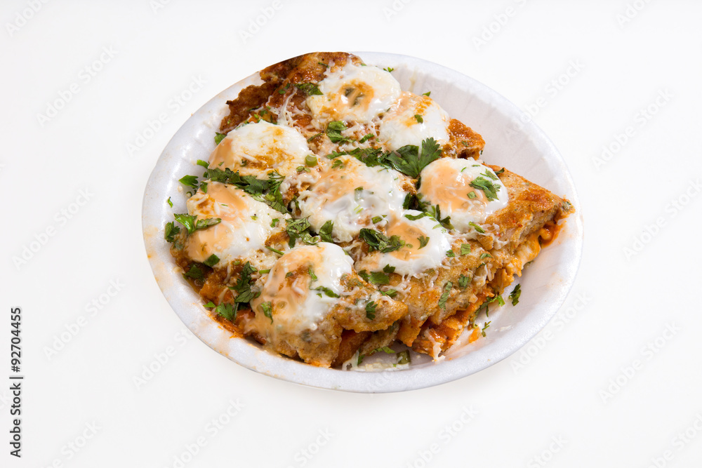 an indian dish Tandoori Omlette in which bread is rolled between an omlette and slightly baked then topped with mayonnaise and cheese isolated on white background available with clipping mask