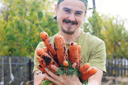 Farmer offering carrots photo