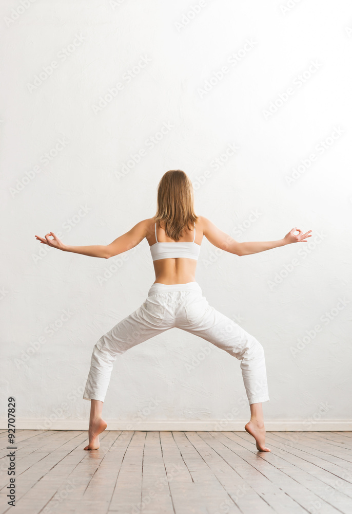 Young and sporty girl training in gym. Yoga exercise. Young and sporty girl training in gym. Yoga exercise.